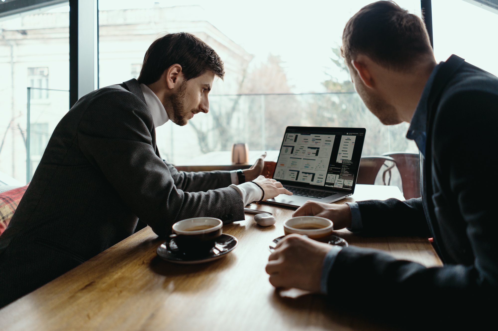 two-young-businessman-having-successful-meeting-restaurant